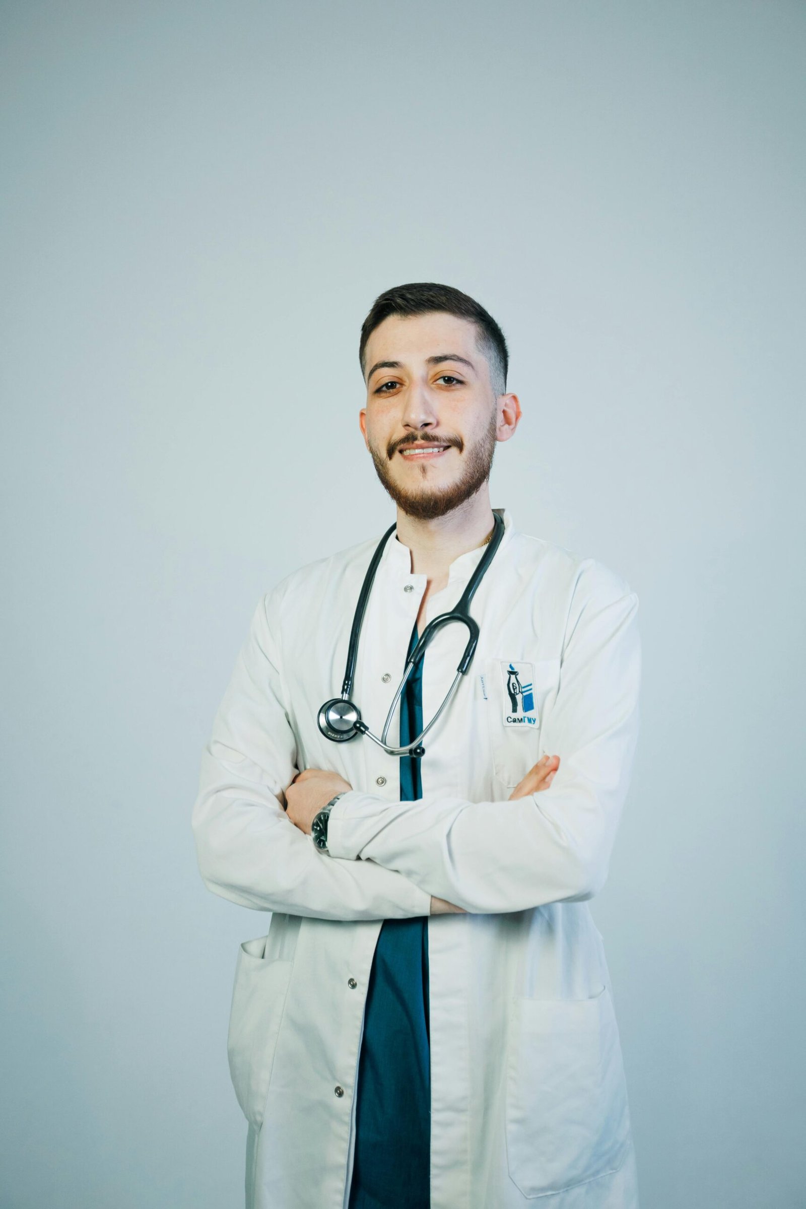 Portrait of a young male doctor with a stethoscope, exuding confidence and professionalism.